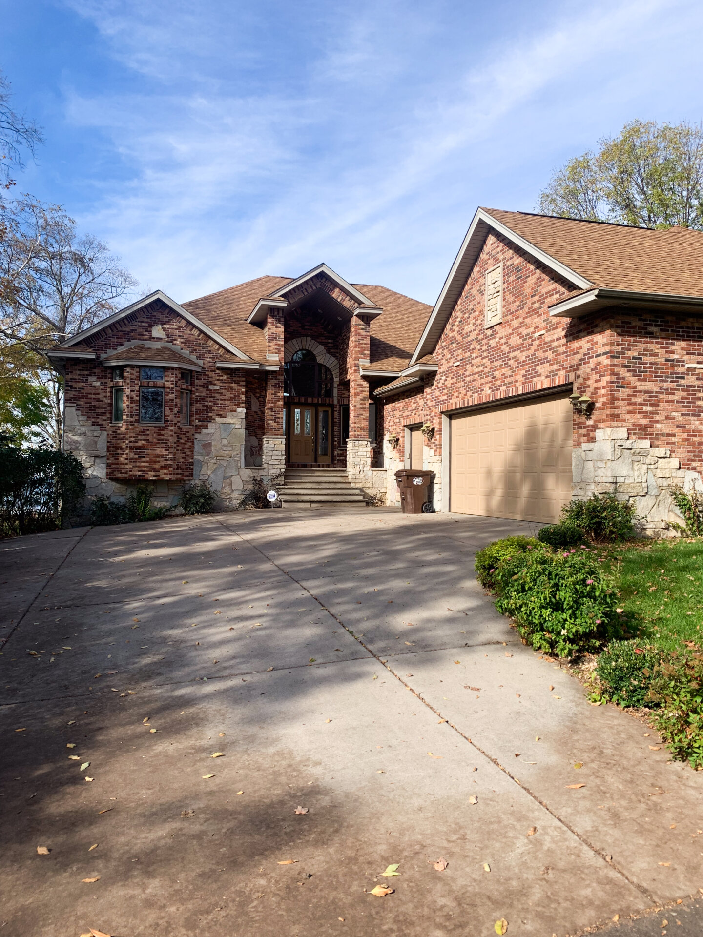 Roadside view of the Accessible Sunset property, a large brick house among trees