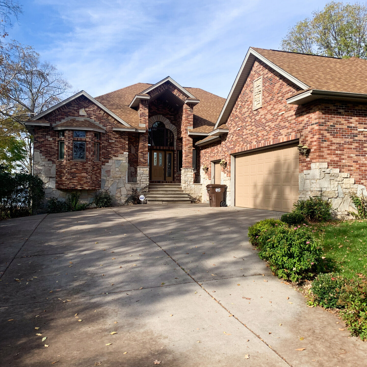 Roadside view of the Accessible Sunset property, a large brick house among trees